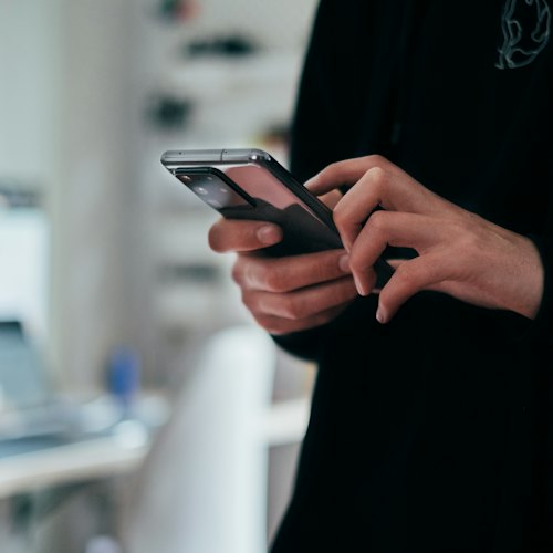 Hands searching on a smartphone